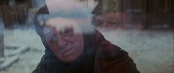 Movie still from “Fiddler on the Roof” (1971), directed by Norman Jewison – An old man and a woman looking out a window; Close Up shot, Low angle