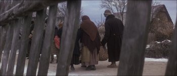Movie still from “Fiddler on the Roof” (1971), directed by Norman Jewison – A group of people walking down a street holding hands; Wide shot, High angle