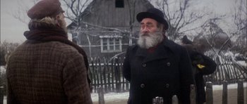 Movie still from “Fiddler on the Roof” (1971), directed by Norman Jewison – An old man with a long beard wearing a black hat; Close Up shot, Over the shoulder angle