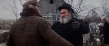 Movie still from “Fiddler on the Roof” (1971), directed by Norman Jewison – An old man with a long beard wearing a black hat; Close Up shot, Over the shoulder angle