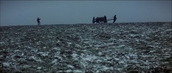 Movie still from “Fiddler on the Roof” (1971), directed by Norman Jewison – Two people are pulling a cart across a snowy field; Extreme Wide shot, Low angle
