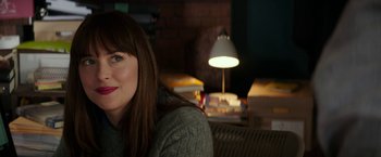 Movie still from “Fifty Shades Darker” (2017), directed by James Foley – A person sitting in front of a lamp; Close Up shot, Over the shoulder angle