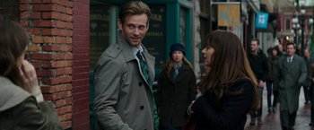Movie still from “Fifty Shades Darker” (2017), directed by James Foley – A man wearing a jacket and a neck tie standing next to a woman wearing a jacket; Medium shot, Over the shoulder angle