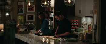 Movie still from “Fifty Shades Darker” (2017), directed by James Foley – A man and a woman cutting vegetables in a kitchen; Medium shot, High angle