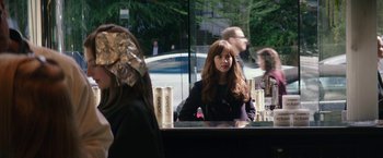 Movie still from “Fifty Shades Darker” (2017), directed by James Foley – A woman sitting in front of a mirror in front of a building; Close Up shot, Over the shoulder angle