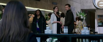 Movie still from “Fifty Shades Darker” (2017), directed by James Foley – A group of people standing in a room; Medium shot, Over the shoulder angle