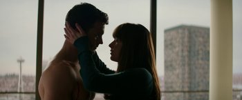 Movie still from “Fifty Shades Darker” (2017), directed by James Foley – A man and a woman touching their heads; Medium shot, Over the shoulder angle