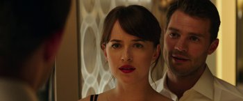 Movie still from “Fifty Shades Darker” (2017), directed by James Foley – A person wearing a dress; Close Up shot, Over the shoulder angle