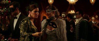 Movie still from “Fifty Shades Darker” (2017), directed by James Foley – Two women dressed up in costumes for a masquerade ball; Medium shot, Over the shoulder angle