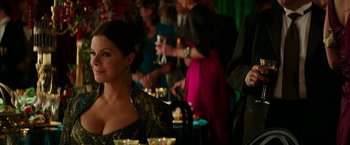 Movie still from “Fifty Shades Darker” (2017), directed by James Foley – A woman sitting at a table in front of a group of people; Close Up shot, Over the shoulder angle