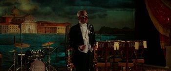 Movie still from “Fifty Shades Darker” (2017), directed by James Foley – A man in a tuxedo with a skull mask on his face; Wide shot, High angle