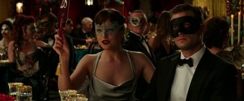 Movie still from “Fifty Shades Darker” (2017), directed by James Foley – A woman wearing a mask at a masquerade ball; Close Up shot, Over the shoulder angle