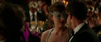 Movie still from “Fifty Shades Darker” (2017), directed by James Foley – A woman wearing a silver mask and a man wearing a silver mask; Close Up shot, Over the shoulder angle