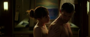Movie still from “Fifty Shades Darker” (2017), directed by James Foley – A man and a woman in a room with a painting; Medium shot, High angle