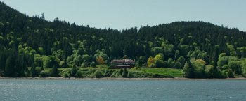 Movie still from “Fifty Shades Darker” (2017), directed by James Foley – A house on the side of a lake surrounded by a forest; Extreme Wide shot, High angle