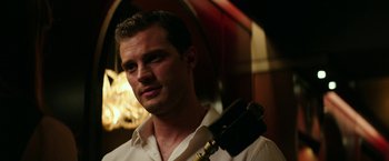 Movie still from “Fifty Shades Darker” (2017), directed by James Foley – A person holding a microphone; Close Up shot, Over the shoulder angle