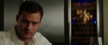 Movie still from “Fifty Shades Darker” (2017), directed by James Foley – A person wearing a white dress shirt; Close Up shot, Over the shoulder angle