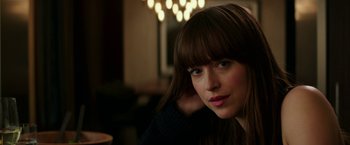 Movie still from “Fifty Shades Darker” (2017), directed by James Foley – A person sitting in a room; Close Up shot, Over the shoulder angle