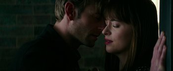 Movie still from “Fifty Shades Darker” (2017), directed by James Foley – A man and a woman face to face in the dark; Close Up shot, Overhead angle
