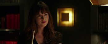 Movie still from “Fifty Shades Darker” (2017), directed by James Foley – A beautiful woman with long brown hair holding a white stick; Close Up shot, Over the shoulder angle