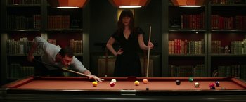 Movie still from “Fifty Shades Darker” (2017), directed by James Foley – A woman standing at the edge of a billiards table; Medium shot, High angle