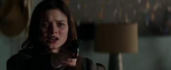 Movie still from “Fifty Shades Darker” (2017), directed by James Foley – A woman holding a gun in her hand; Close Up shot, Over the shoulder angle