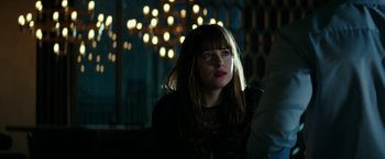 Movie still from “Fifty Shades Darker” (2017), directed by James Foley – A woman with long brown hair sitting in front of a mirror; Close Up shot, Over the shoulder angle