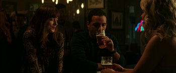 Movie still from “Fifty Shades Darker” (2017), directed by James Foley – A man and a woman sitting at a table drinking beer; Medium shot, Over the shoulder angle