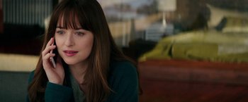 Movie still from “Fifty Shades Darker” (2017), directed by James Foley – A person sitting in a room; Close Up shot, Over the shoulder angle
