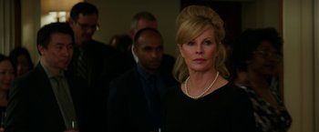 Movie still from “Fifty Shades Darker” (2017), directed by James Foley – A woman in a black dress with a pearl necklace; Close Up shot, Over the shoulder angle