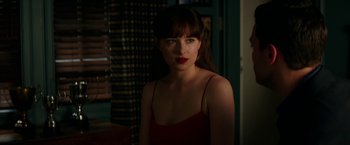Movie still from “Fifty Shades Darker” (2017), directed by James Foley – A woman with red lipstick is posing for a picture; Close Up shot, Over the shoulder angle