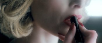 Movie still from “Filth” (2013), directed by Jon S. Baird – View of a woman's mouth and tongue; Extreme Close Up shot, Over the shoulder angle