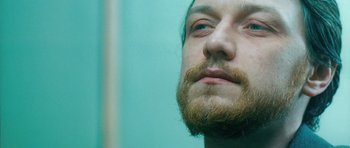 Movie still from “Filth” (2013), directed by Jon S. Baird – A person with a beard; Close Up shot, Low angle