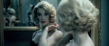 Movie still from “Filth” (2013), directed by Jon S. Baird – A woman is looking in the bathroom mirror; Close Up shot, Over the shoulder angle