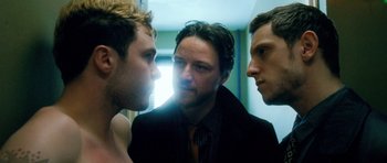 Movie still from “Filth” (2013), directed by Jon S. Baird – Three men in a room looking at each other in a mirror; Medium shot, Over the shoulder angle