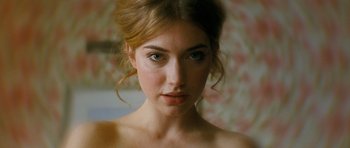 Movie still from “Filth” (2013), directed by Jon S. Baird – A beautiful young lady with a serious look; Close Up shot, Over the shoulder angle