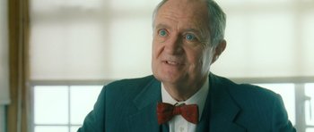 Movie still from “Filth” (2013), directed by Jon S. Baird – An older man wearing a suit and a bow tie; Close Up shot, Low angle