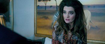 Movie still from “Filth” (2013), directed by Jon S. Baird – A person sitting in a room; Close Up shot, Over the shoulder angle