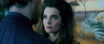 Movie still from “Filth” (2013), directed by Jon S. Baird – A person with long brown hair; Close Up shot, Over the shoulder angle