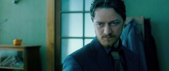 Movie still from “Filth” (2013), directed by Jon S. Baird – A person wearing a suit and tie; Close Up shot, Low angle