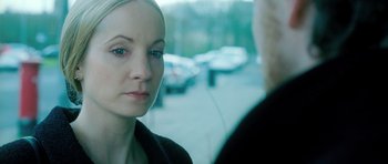 Movie still from “Filth” (2013), directed by Jon S. Baird – A young woman is looking at a older man; Close Up shot, Over the shoulder angle