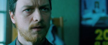 Movie still from “Filth” (2013), directed by Jon S. Baird – A person with a beard; Close Up shot, Over the shoulder angle