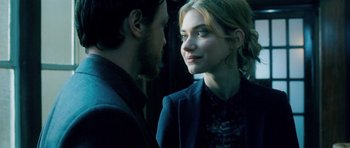 Movie still from “Filth” (2013), directed by Jon S. Baird – A man and a woman standing next to each other; Close Up shot, Over the shoulder angle
