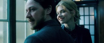 Movie still from “Filth” (2013), directed by Jon S. Baird – A man and a woman smiling for the camera; Close Up shot, Low angle