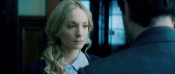 Movie still from “Filth” (2013), directed by Jon S. Baird – A woman with long blonde hair wearing a white shirt; Close Up shot, Over the shoulder angle