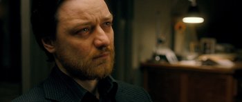 Movie still from “Filth” (2013), directed by Jon S. Baird – A person with a beard; Close Up shot, Over the shoulder angle