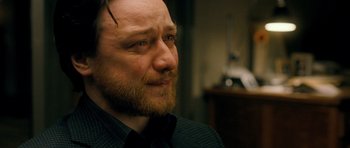 Movie still from “Filth” (2013), directed by Jon S. Baird – A person with a beard; Close Up shot, Over the shoulder angle
