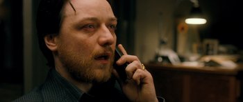 Movie still from “Filth” (2013), directed by Jon S. Baird – A person talking on a cell phone; Close Up shot, High angle