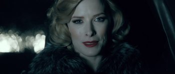 Movie still from “Filth” (2013), directed by Jon S. Baird – A person with blonde hair wearing a fur coat; Close Up shot, Low angle