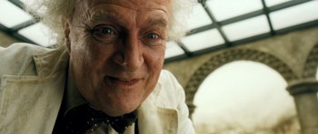 Movie still from “Filth” (2013), directed by Jon S. Baird – An older man with a white shirt and a black bow tie; Close Up shot, Low angle